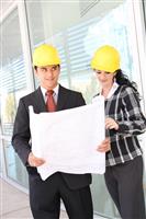 Man and Woman Architects on Construction Site stock photo