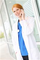 Pretty Nurse on Cell Phone stock photo