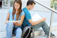 Attractive Couple at School Library Reading stock photo