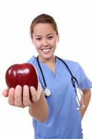 Female doctor holding apple stock photo