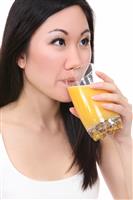 Asian Woman Drinking Orange Juice stock photo