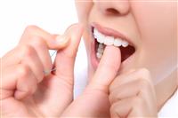 Woman Flossing Her Teeth stock photo