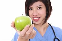 Pretty Asian Nurse with Apple stock photo