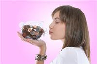 Pretty Woman Kissing Piggy Bank stock photo