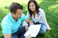 Couple Studying on Grass stock photo