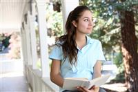 Pretty Girl Reading on Home Porch stock photo