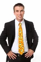 Handsome business man with smiley face tie stock photo