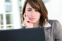 Bored Woman on Laptop Computer stock photo