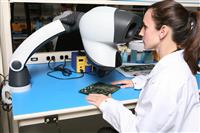 Woman Technician with Microscope stock photo