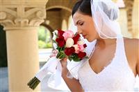 Bride smelling wedding bouquet stock photo