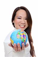 Asian Woman Holding Globe stock photo